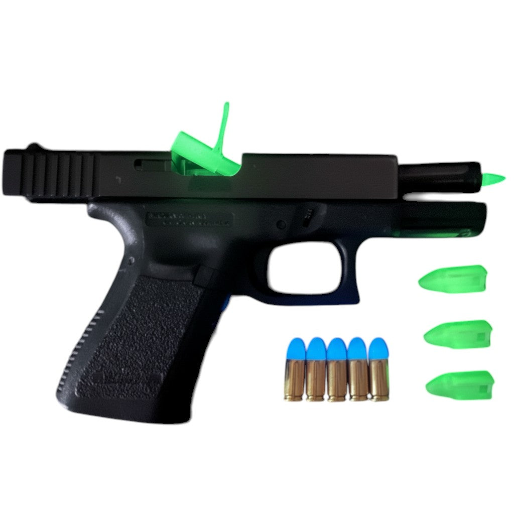 Kombat Line advanced training pack with black pistol, green glow-in-the-dark slide lock, barrel plug, and three dummy rounds, plus five inert blue-tipped rounds.